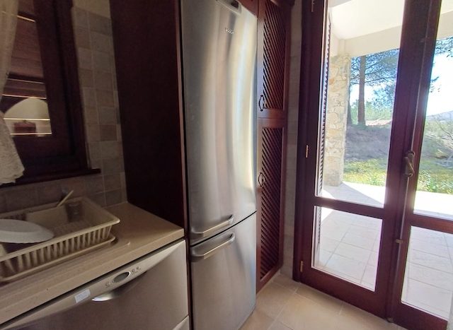 Modern kitchen with fridge and glass door in Mandria Village, Limassol.
