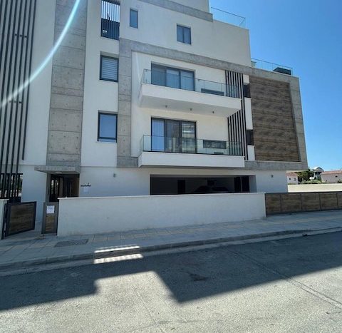 Modern white apartment building in a private complex in Germasogeia, Limassol, with contemporary arc.