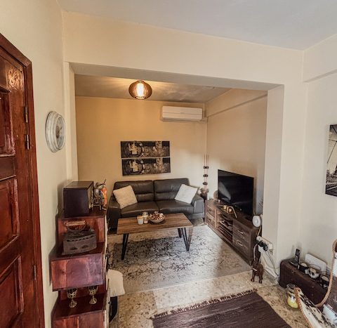 A comfortable living room with a sofa, coffee table, and entertainment area in a ground-floor house.