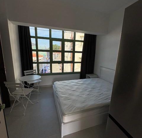 Modern studio for rent in Limassol city center with large window view.