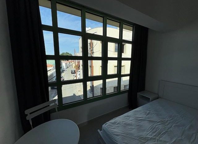 Bright studio apartment with large window view in Limassol city center.
