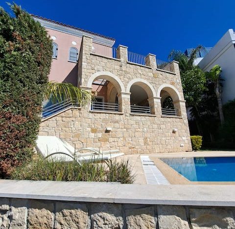 Luxurious waterfront villa with stone facade and private pool in Limassol Marina, Cyprus.